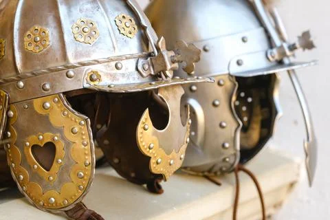 Two knight's helmets are lying on the surface.Medieval concept Stock Photos