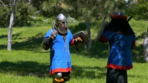 Two knights inflict crushing blows to each other with swords. Stock Footage 122080593