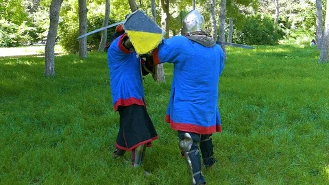 Two knights practice a counterattack with a sword during a training session in t Stock-Footage 122080006