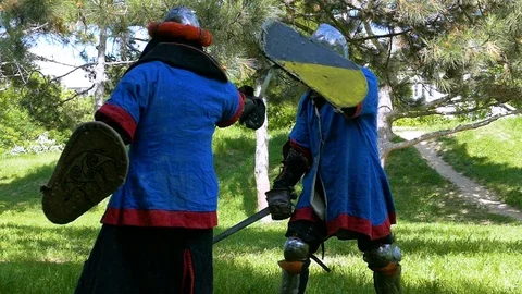 Two knights practice sword attacks Stock Footage 122079984