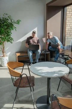 Two knowledgeable professionals collaborating effectively together in a modern Stock Photos
