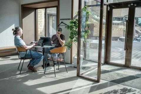 Two knowledgeable professionals collaborating effectively together in a modern Stock Photos