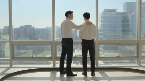 Two Korean Businessmen Shaking Hands Outdoors with City View 스톡 동영상 338041129