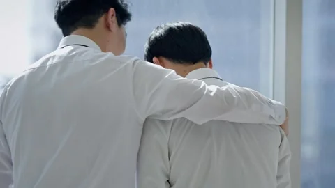 Two Korean Businessmen Talking from Behind in Bright Office Stock-Footage 337990407