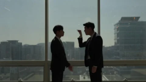 Two Korean Businessmen Talking by Bright Office Window 스톡 동영상 338039635