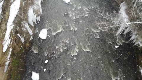 Two Kyakers going down a river during a snow storm Stock Footage 101611984