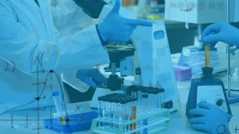 Two lab staff lowering yellow tube into vortex, causing red formulas animating Stock Footage 330444175