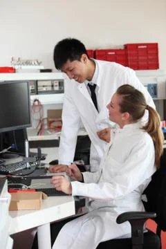 Two lab technicians discussing their work Stock Photos