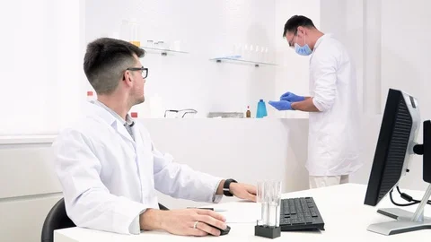 Two laboratory assistants, pharmaceutical workers are developing new medicines Stock Footage 118045135