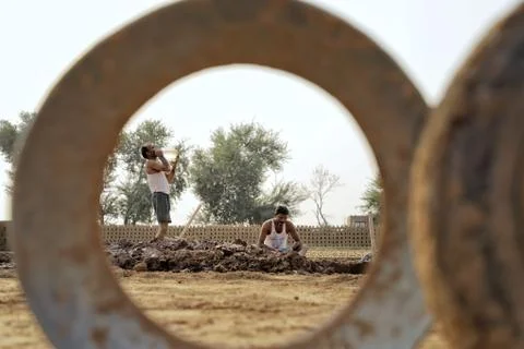 Two labour working in a mud at bricks factory Stock Photos