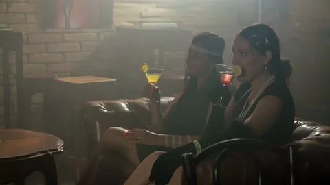 Two ladies are slowly drinking their cocktails Stock Footage 112195213