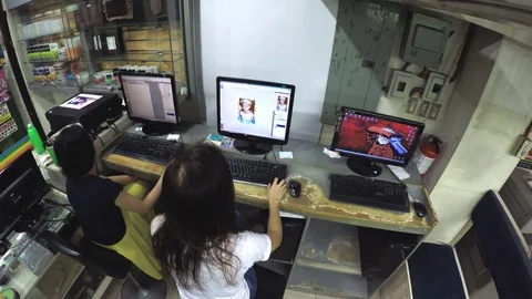 Two Ladies desktop operator viewing images on desktop monitor 스톡 동영상 77350317