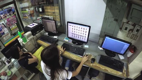 Two Ladies desktop operator viewing images on desktop monitor 스톡 동영상 77449555