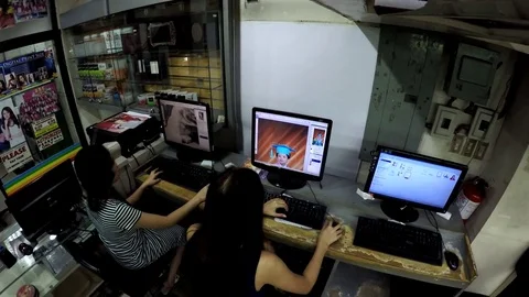 Two Ladies desktop operator viewing images on desktop monitor 스톡 동영상 77452760