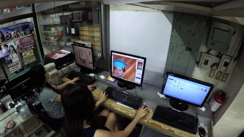 Two Ladies desktop operator viewing images on desktop monitor 스톡 동영상 77458001