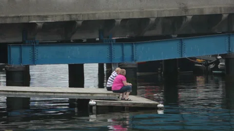 Two ladies waited on a small pier Stock Footage 35252953