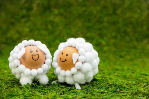 Two lamb shaped eggs on green moss with copyspace, concept spring or easter s 库存照片
