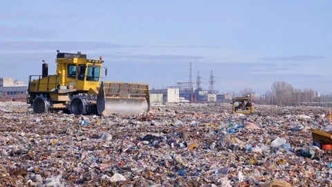 Two landfill compactors move across a landfill side. Stock Footage 81243446