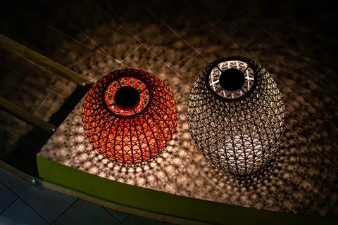 Two lanterns, one red and one black, are lit up Stock Photos