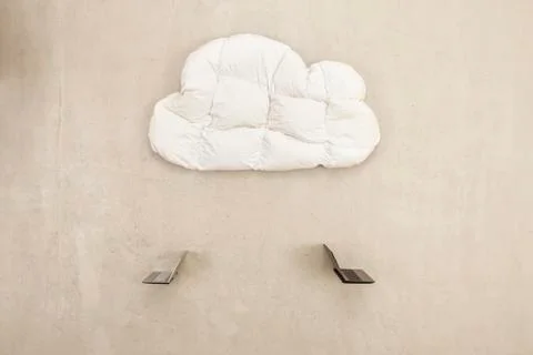 Two laptops below cloud shape pillow Stock Photos
