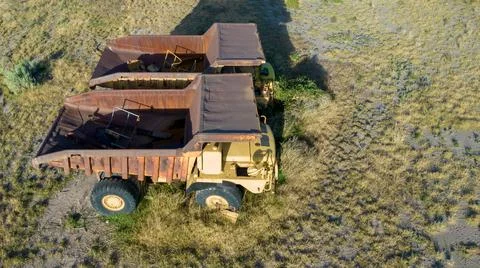 Two large abandoned mining trucks. Aerial view. Stock Photos