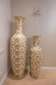 Two large antique beige vases. pitcher standing in the interior of the house. Stock Photos