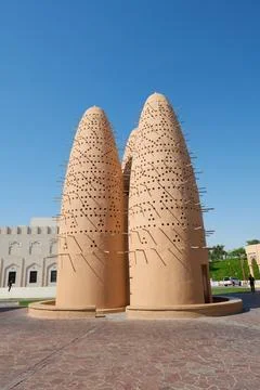 Two large architectural objects in front of a building with a green lawn Stock Photos
