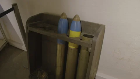 Two large artillery shells stored in a wooden rack Stock Footage 301162002