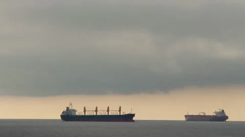Two large barge ships under a cloudy sunrise sky Stock Footage 40953444