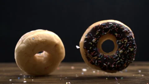 Two large donuts falling into table surface in super slow-motion at 800 fps.. Stock Footage 273370149