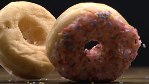 Two large donuts falling into table surface in super slow-motion at 800 fps.. Stock Footage 273371169
