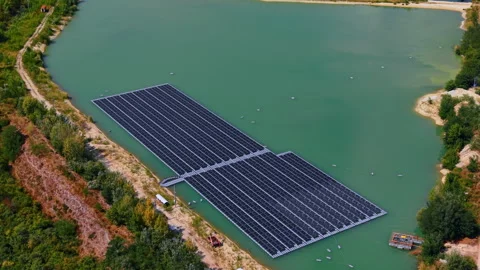 Two large floating solar panel arrays set on the artificial lake with turquoise 動画素材 346190219