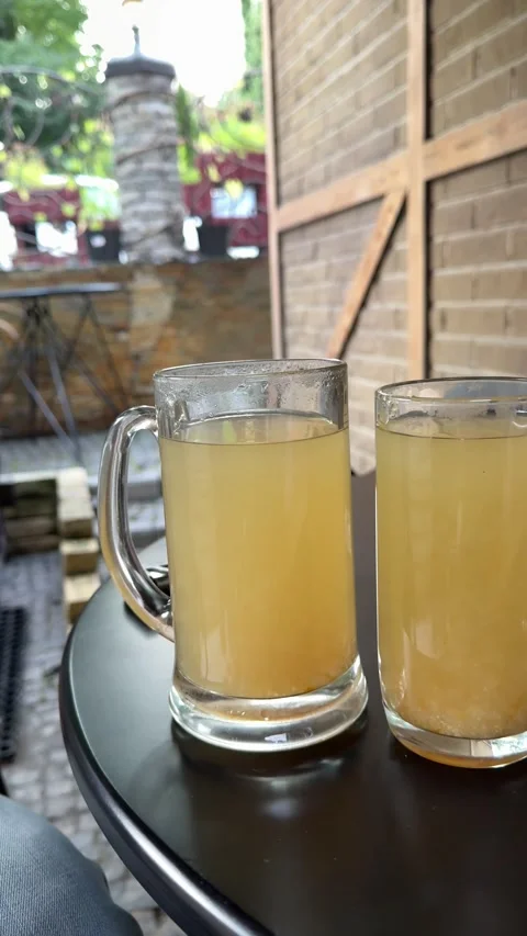 Two large glass mugs of hot lemon drink Stock Footage 317710196