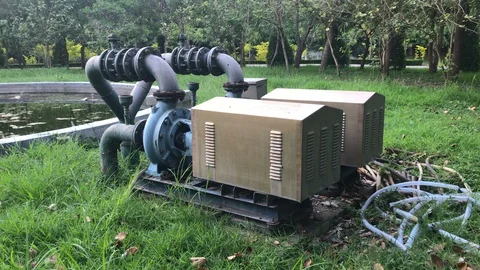 Two Large Industrial Scale Water Pumps To Water Pond and Plants at Public City Stock Footage 130098346