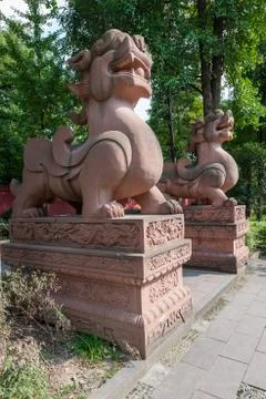 Two large lion stone statues in a buddhist temple 스톡 사진