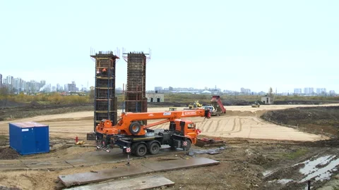 Two large metal structures on the construction site. Workers at a lorry at a Video stock 95182209