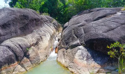 Two Large Mountainous Rock Objects With Small Rivers Flowing Stock Photos
