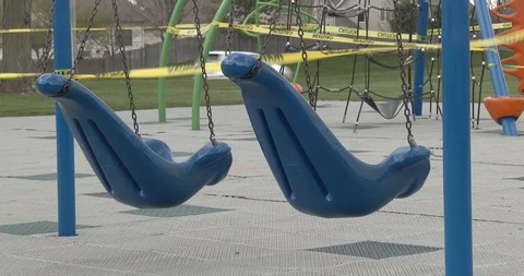 Two large Plastic Swings - Empty Playground - Pandemic Stock Footage 128783821