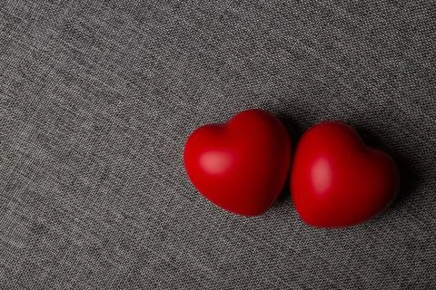 Two large red hearts on a textile background close up Foto stock