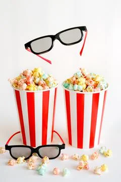 Two large red striped cups with popcorn Stock Photos