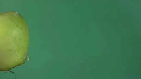 Two large ripe green apples are colliding on the green background Stock Footage 136366218