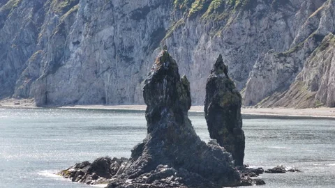 Two Large Rocks Emerging From the Water Stock Footage 265842586