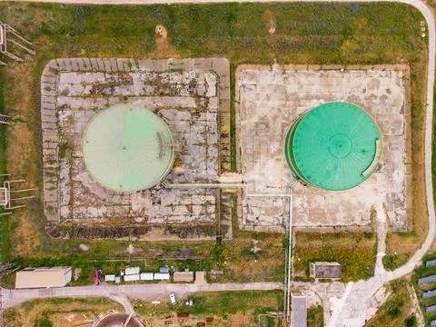 Two large storage tanks are seen from above at a facility in a rural area d.. Stock Photos