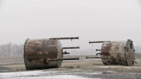 Two Large Water containers junked in farm field winter fog Stock Footage 89945121