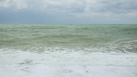 Two large waves roll up and break about the shore Stock-Footage 82124793