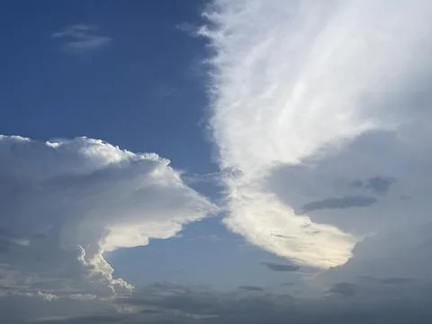 Two Large White Cumulus Clouds Gathering In Blue Sky Horizontal Stock Photos
