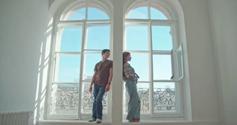 At two large windows, in one apartment, a man and a woman are separated. quarrel 스톡 동영상 172292661