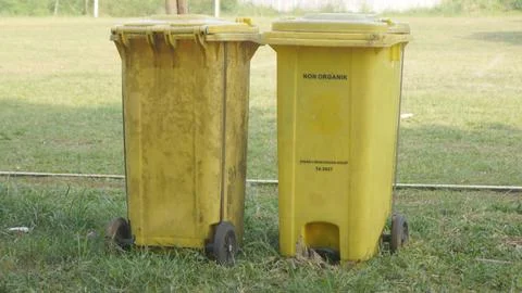 Two large yellow trash cans for recycling or "trash cans"  Stock-Fotos