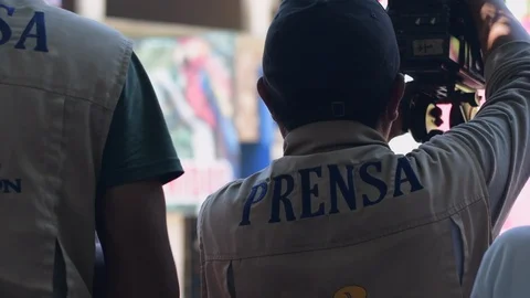 Two latin camera men working as press/news reporters in Guatemala Stock Footage 114838780