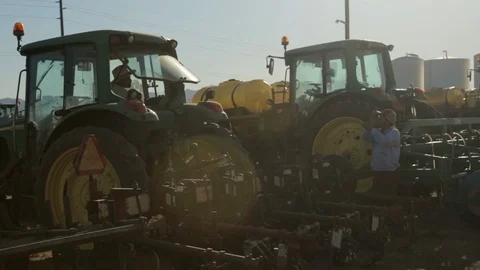 Two Latino Tractor Drivers Talking Stock Footage 95614090